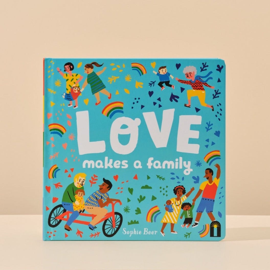 This image features the cover of Love Makes a Family written by Sophie Beer that is included in Handsel's Champagne Baby Showers gift bundle. The image is shot with a natural background. 