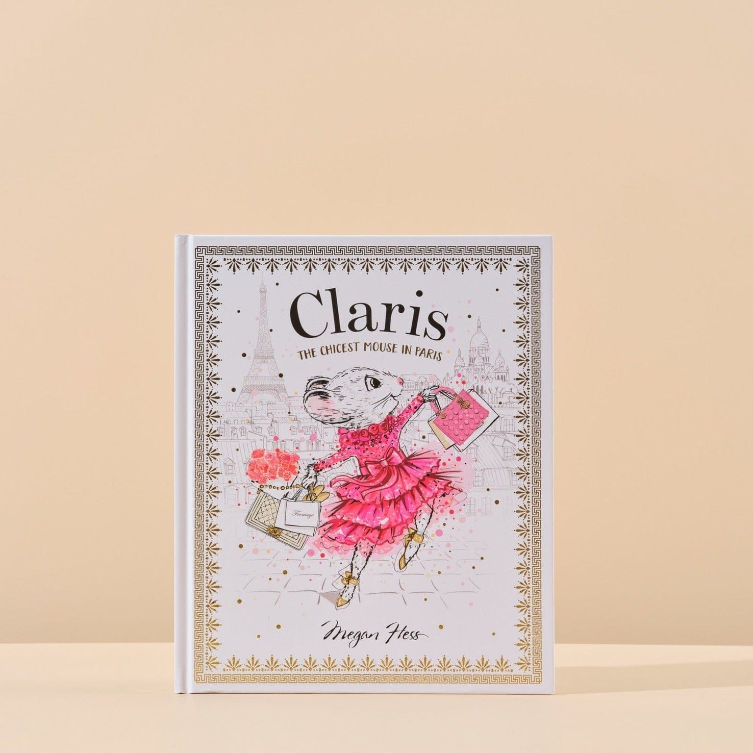 This image features the cover of Claris the Chicest Mouse in Paris written by Megan Hess that is included in Handsel's Champagne Baby Showers gift bundle. The image is shot with a natural background.
