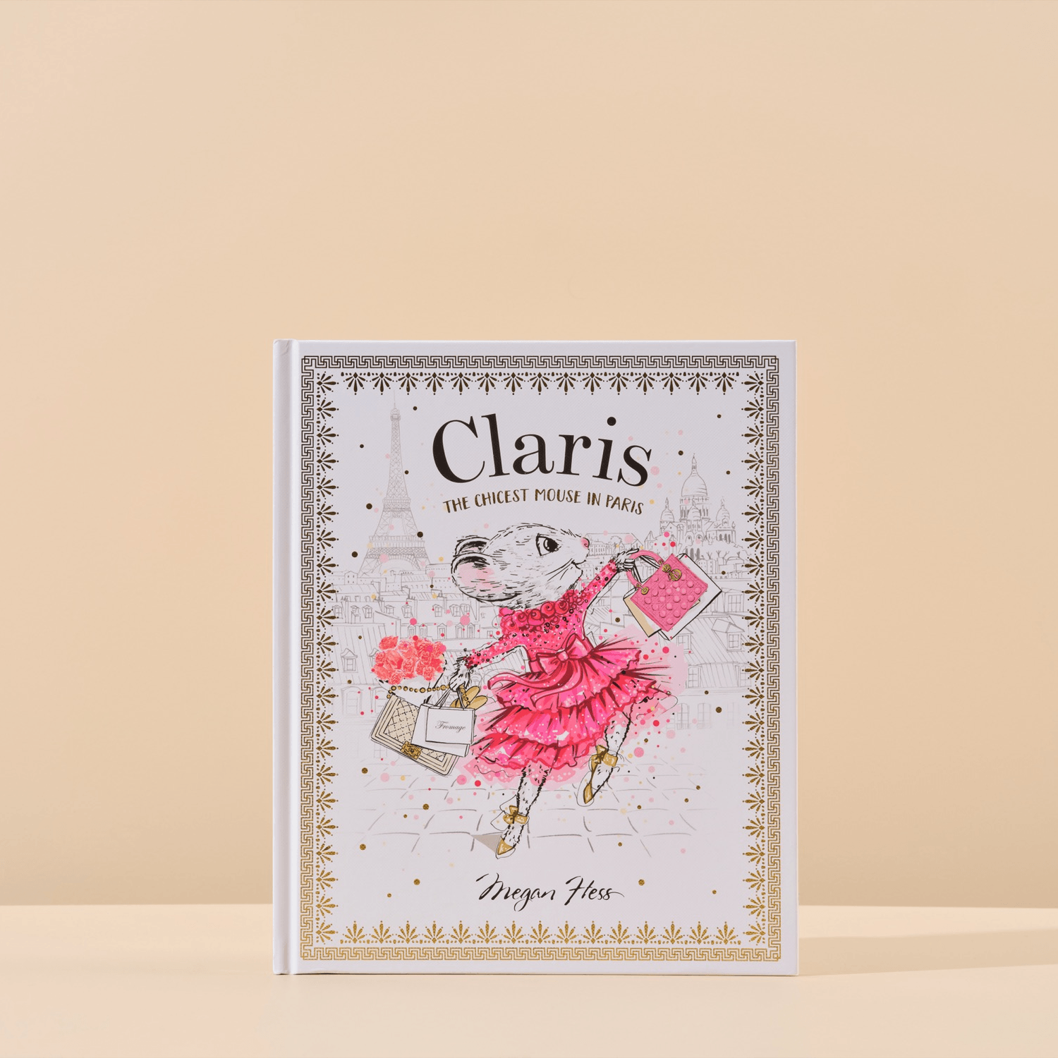 This image features the cover of Claris the Chicest Mouse in Paris written by Megan Hess that is included in Handsel's Champagne Baby Showers gift bundle. The image is shot with a natural background.