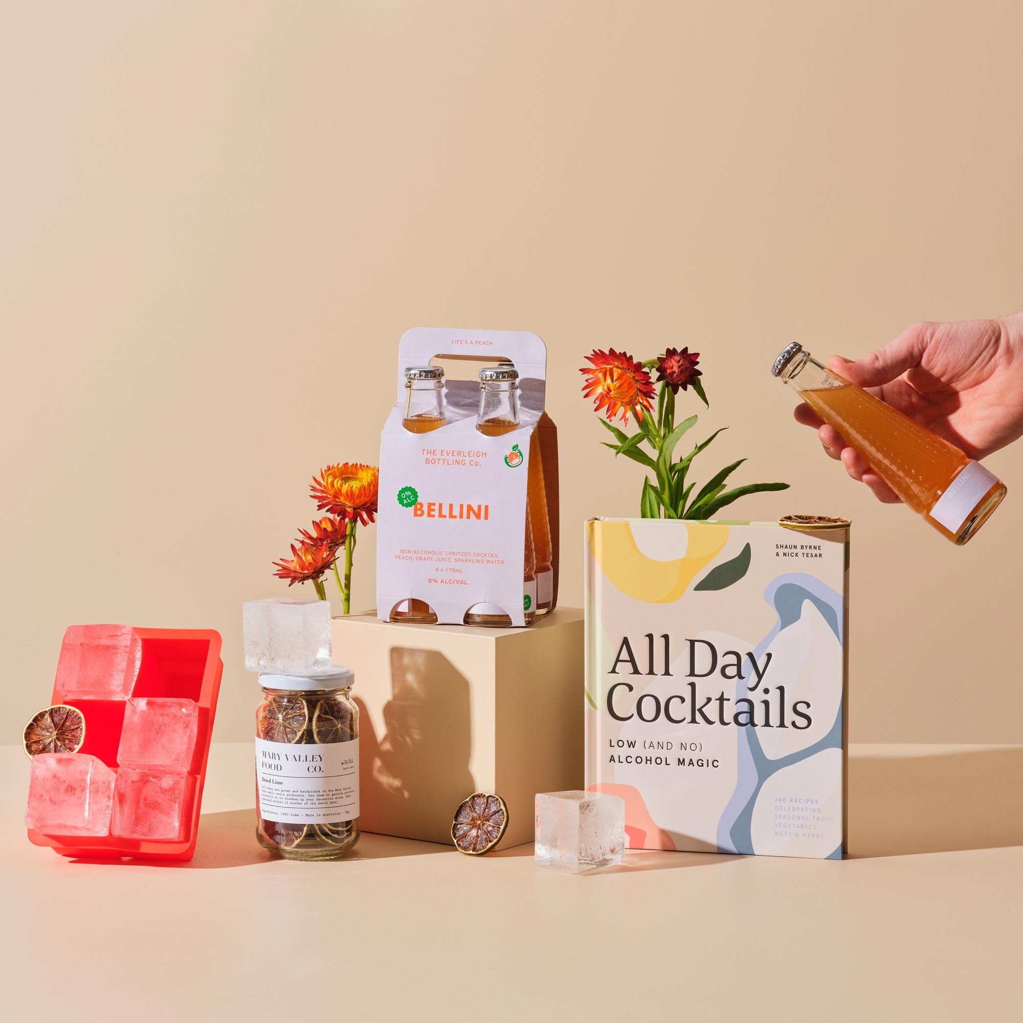 This is the Designated Driver bundle from Handsel. Included in this image is All Day Cocktails, Dried Lime Garnish, %0 Bellini 4 pack and an Ice cube tray