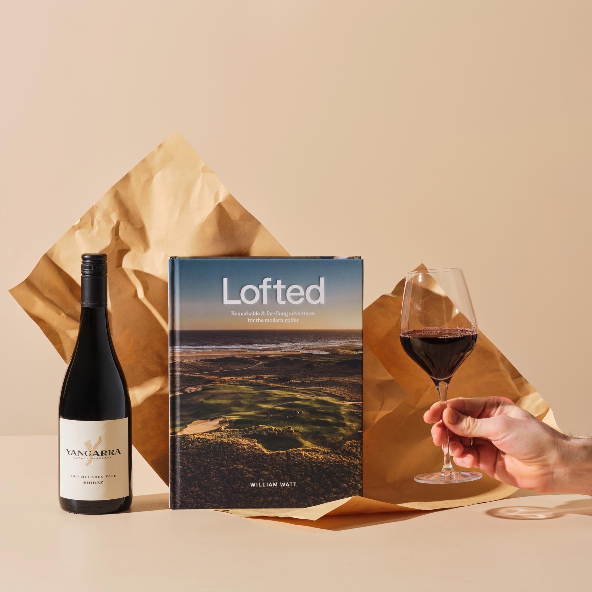 This image features Handsel's 'Par None' gift bundle that includes the cover of Lofted and 2019 Yangarra Shiraz poured into wine glass