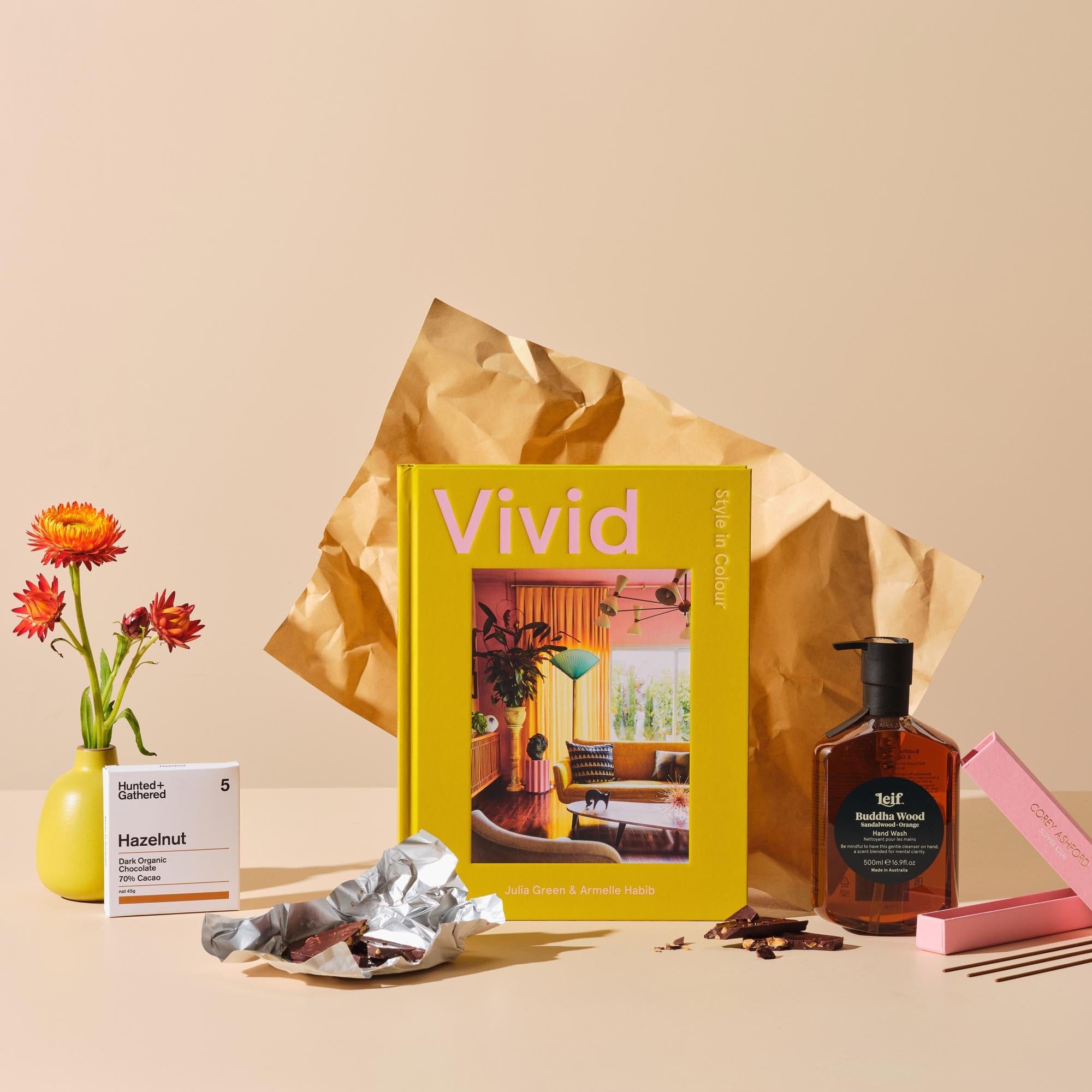 This is the Happy Place bundle from Handsel. Included in this image is Vivid, Dark chocolate, April Blossom Candle, Buddha Wood hand wash and Incense