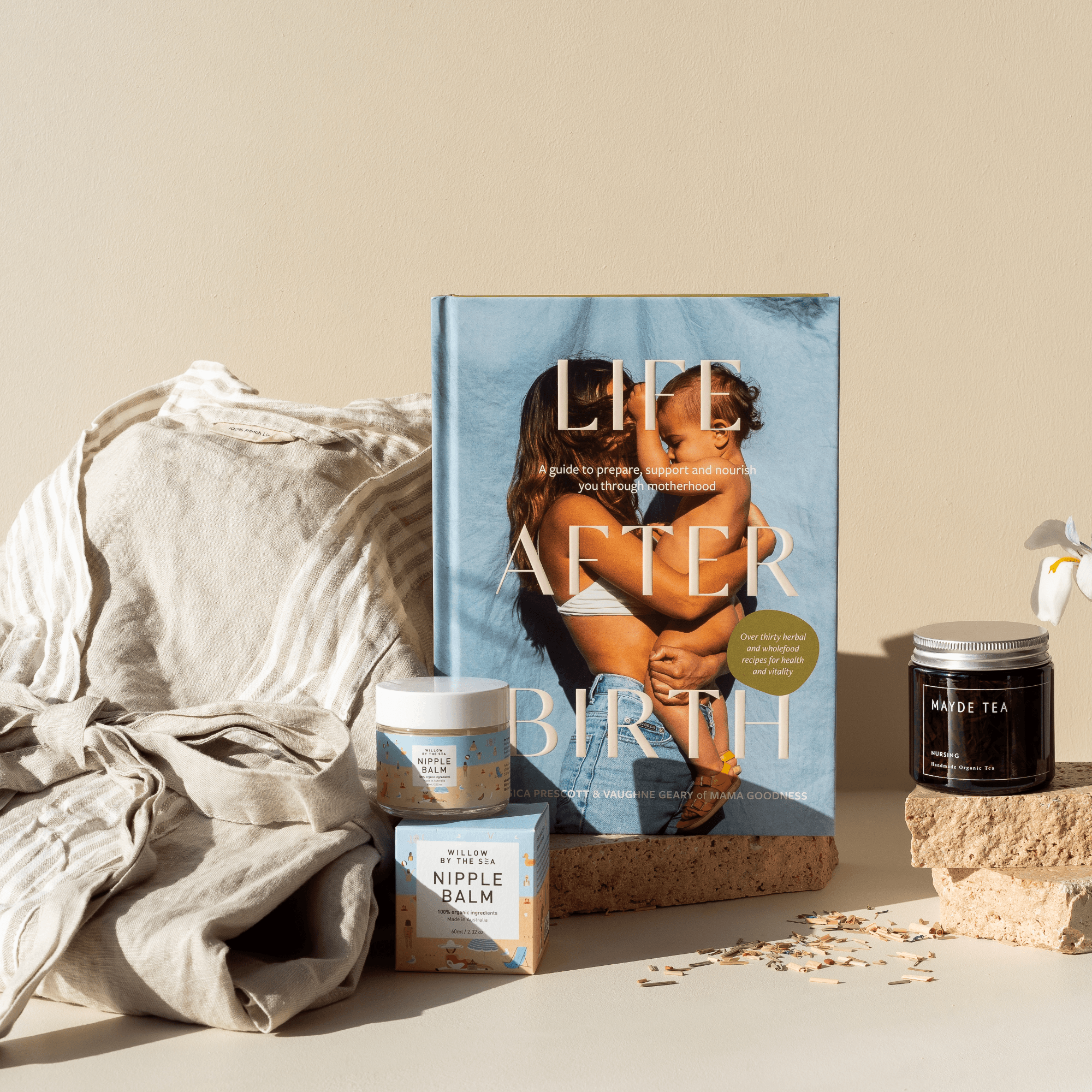 This image shows our Nourish and Nurture gift hamper, with Life After Birth, Mayde Tea, Willow by the Sea Nipple Balm and Carlotta and Gee's Natural colour linen robe. 